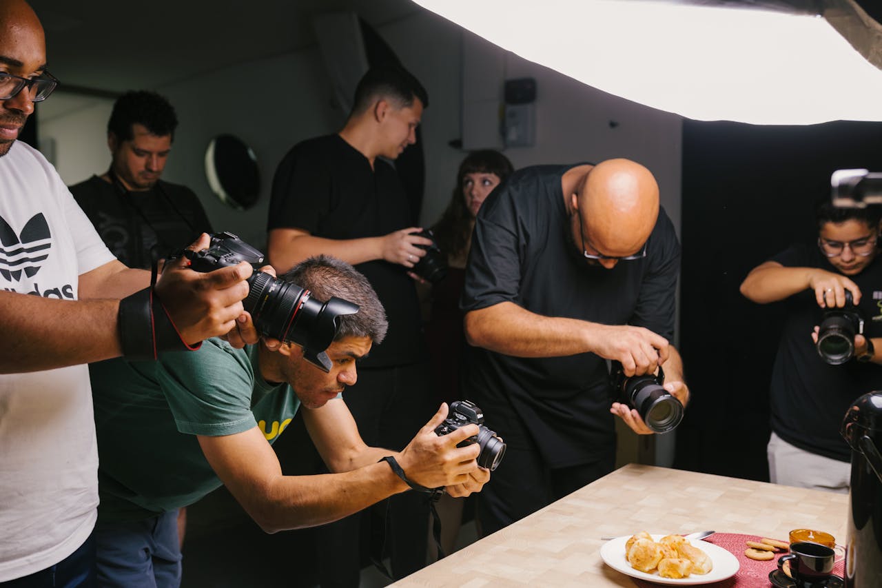 Photographers capturing a delicious Brazilian dish under studio lights.